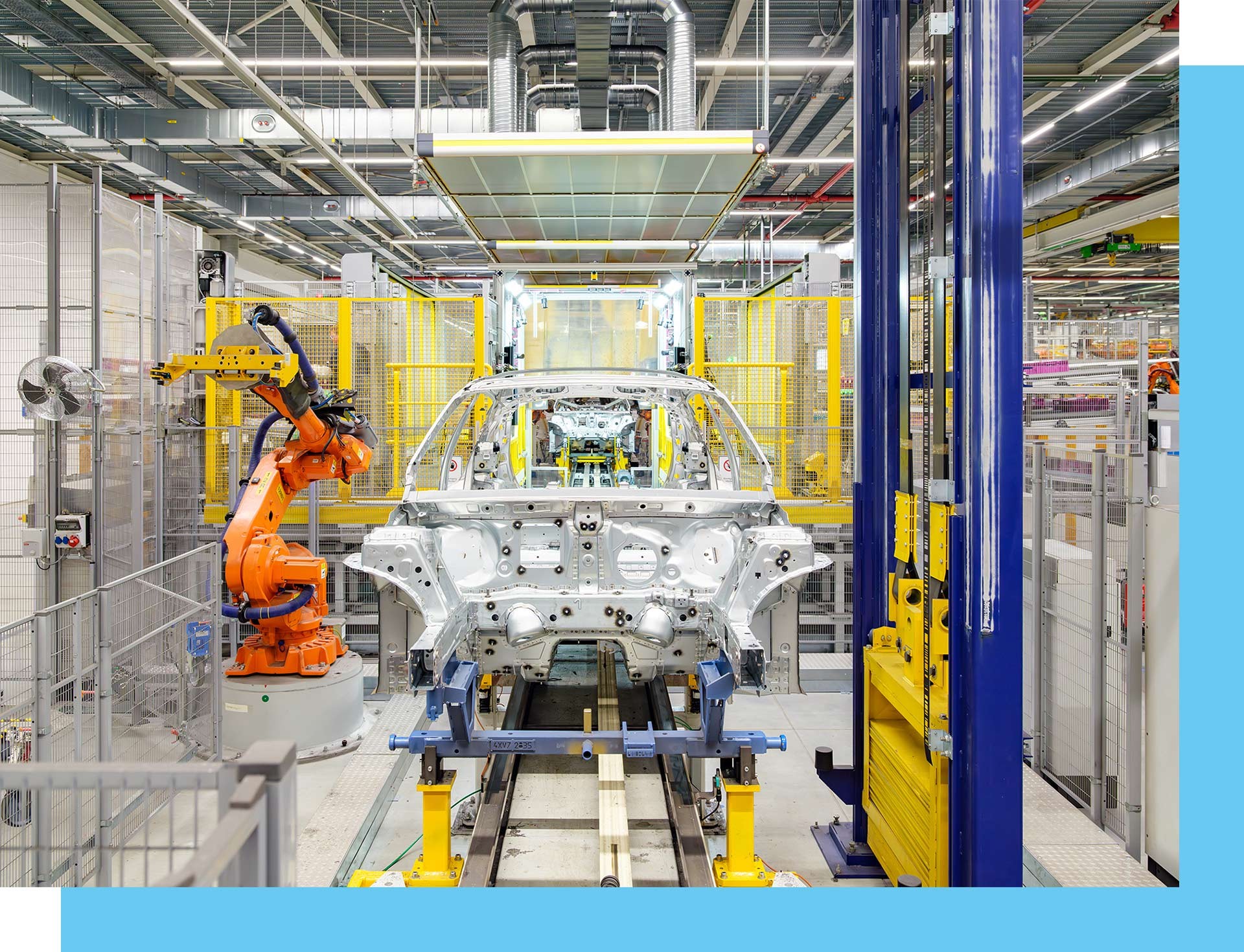 Front-facing view of a car body shell as it is worked on by one of the Plant Leipzig robots.